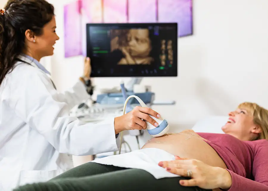 Medical professional preforming Ultrasound and getting 4D footage of baby in pregnant woman's belly - Effingham, IL